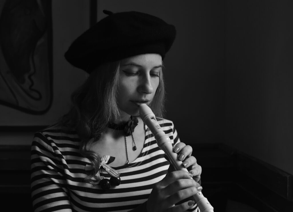 mulher tocando flauta doce